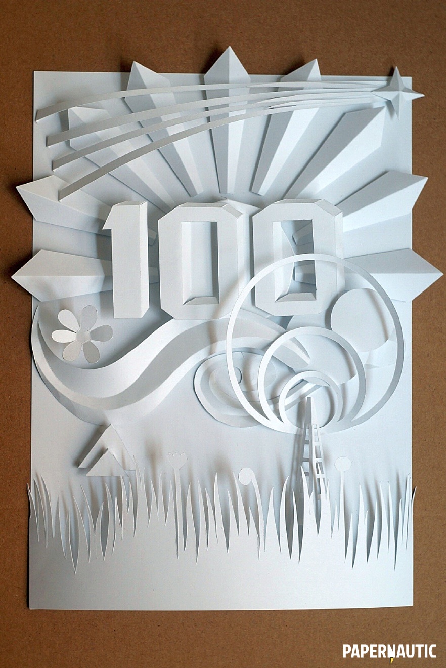 Final paper sculpture in white paper on a cardboard brown background
